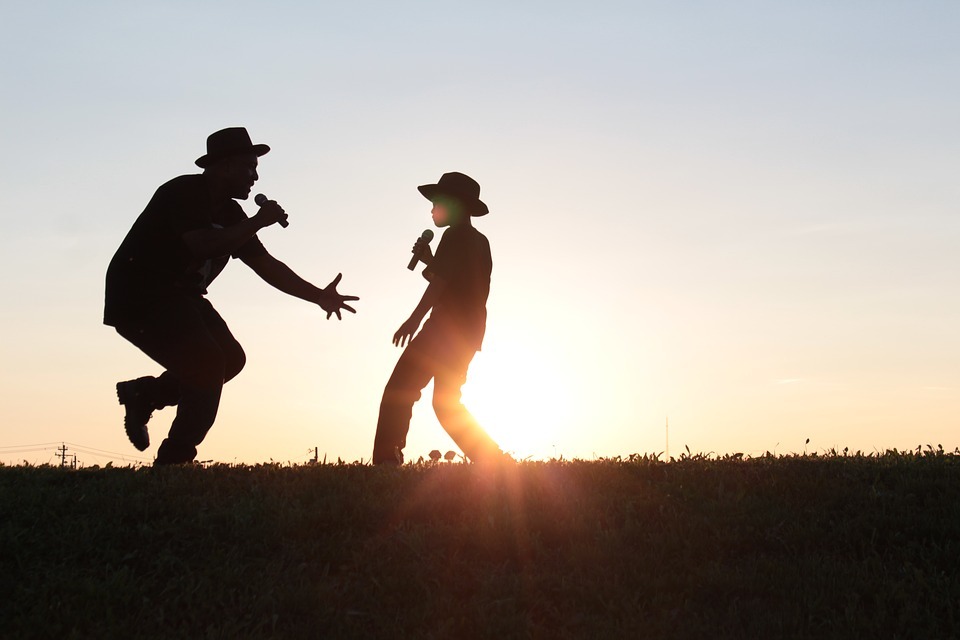 Silhouette of father and son dancing