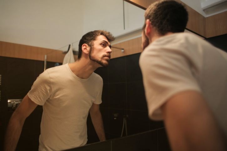 Man looking in the mirror