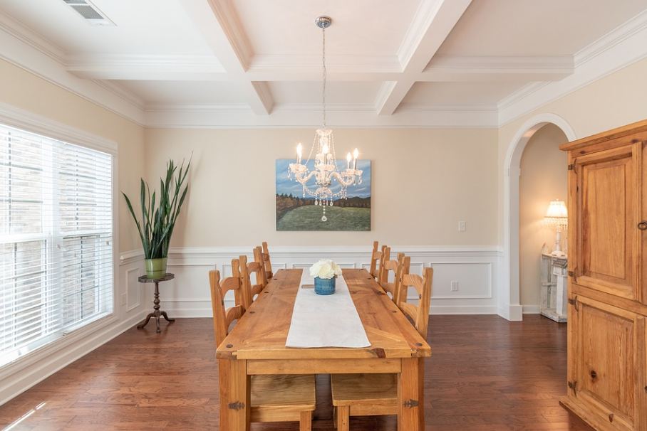 a dining room with a plain white coffered ceiling
