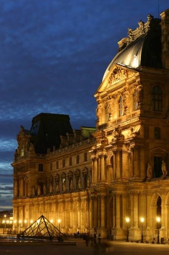 The Louvre in Paris, France, big museum, night setting