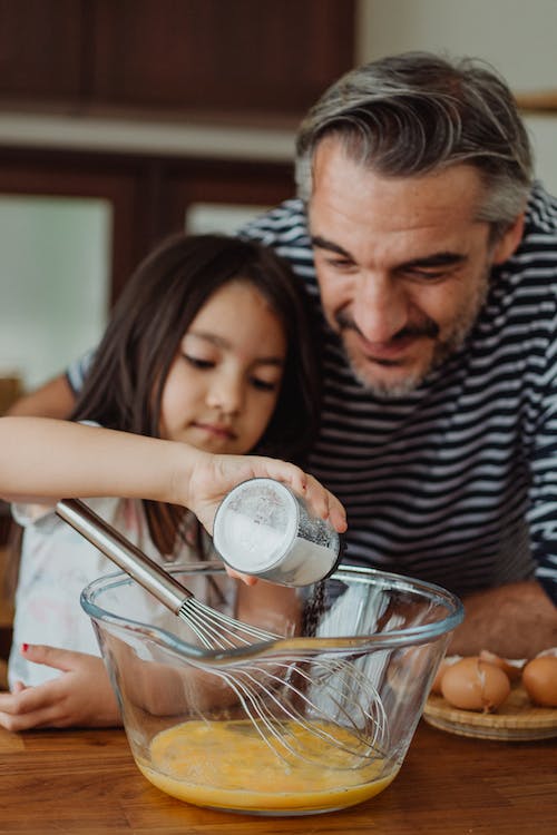 picture of a father and daughter cooking together